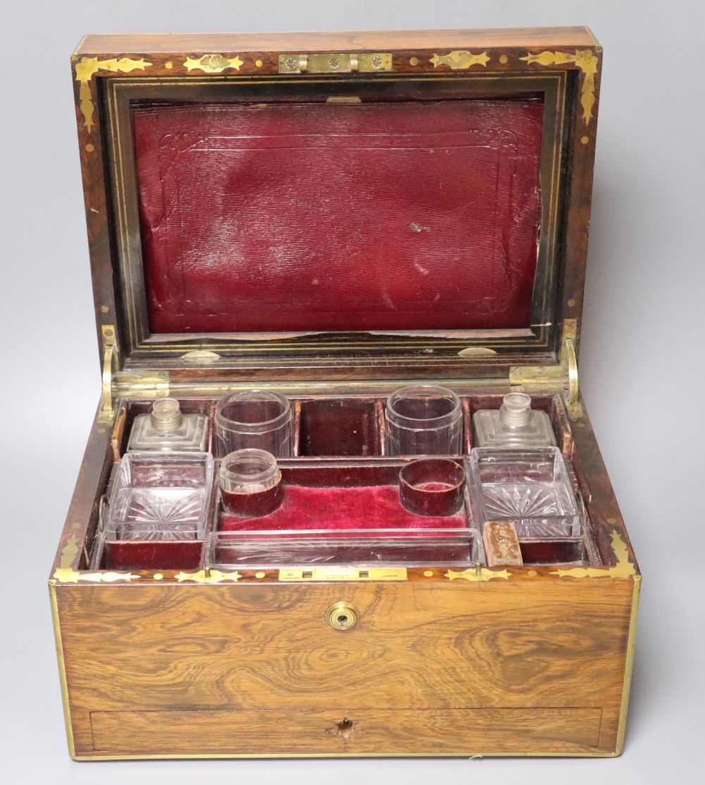 A Regency brass mounted rosewood toilet box, with glass contents and base drawer, width 36cm